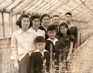 Nobuji and Tame Yoshida with their 6 children at their Edes Ave. nursery, 1940. 